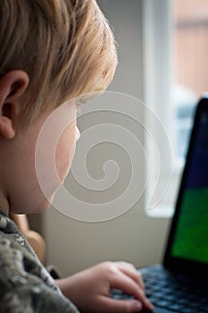 Small boy browsing the interent