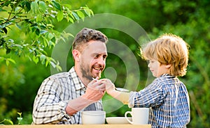 Small boy child with dad. father and son eat outdoor. they love eating together. Weekend breakfast. healthy food. Family