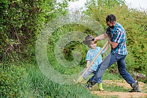 Small boy child help father in farming. new life. soils and fertilizers. rich natural soil. Eco farm. Ranch. father and