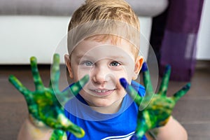 Small boy with colorful hands