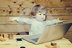 Small boy with computer and phone
