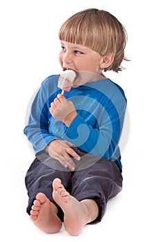 Small boy eating ice lolly