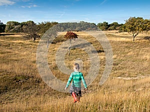 Small boy exploring dune landscape