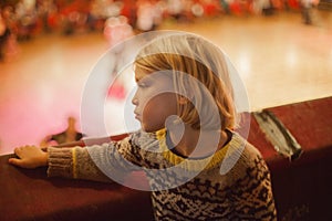 A small boy gazes down at some ballroom dancers