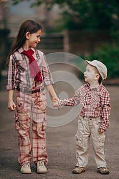 Small boy and his sister go for the walk