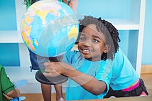 Small boy holding a globe of the world