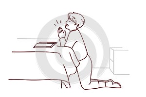 Small boy kneel pray at home
