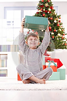 Small boy laughing with christmas present