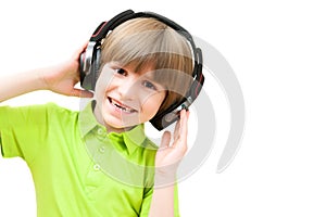 The small boy is listening to music