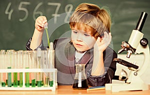 Small boy with microscope at school lesson. student do science experiment with microscope in lab. microscope at lab