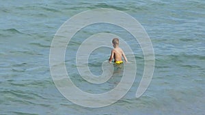 Small boy playing on the beach