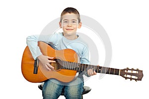 Small boy playing guitar