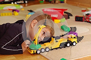 Small boy playing with toy truck