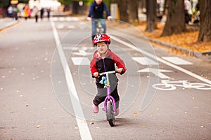 Small boy riding balance bike in action