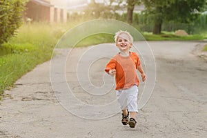 Small boy running forward. He is happy and funny