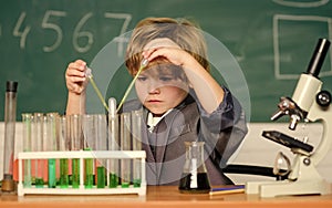small boy at science camp. microscope at lab. Scientific experiment. Pupil looking through microscope. student do