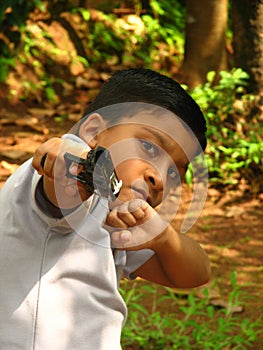 A small boy showing the gun.
