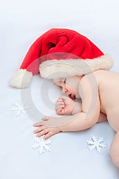 Small boy sleeping in a New Year's cap