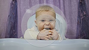 A small boy tastes the lemon.