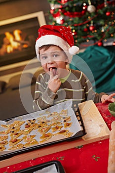 Small boy tasting christmas cake