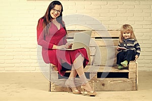 Small boy and teacher girl in glasses, blogging