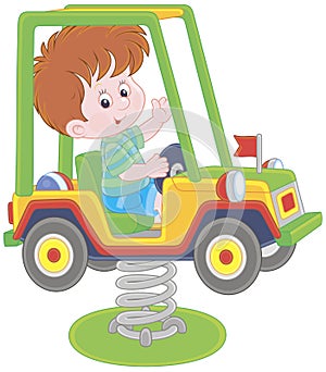 Small boy on a toy car swing on a playground