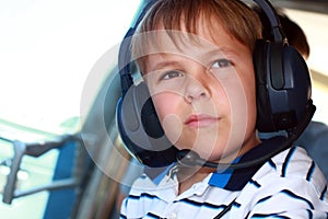 Small boy wearing headset in airplane