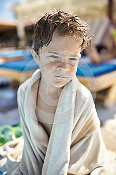 Small boy with wet hair posing on resort