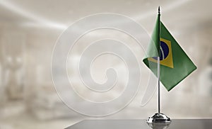 A small Brazil flag on an abstract blurry background