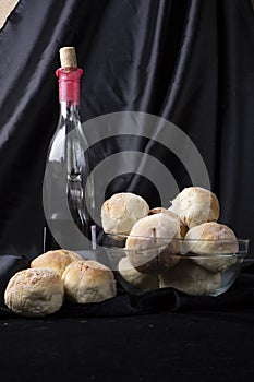 Small breads close-up and bottle of red wine