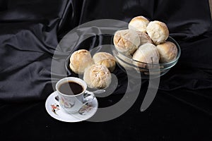 Small breads close-up and a cup of coffee