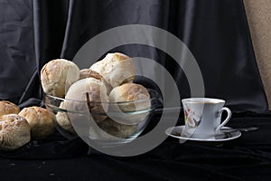 Small breads close-up and a cup of coffee