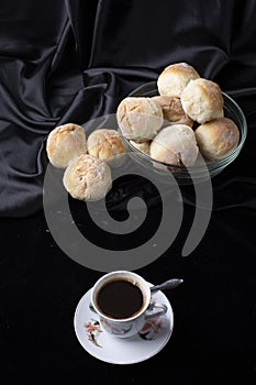 Small breads close-up and a cup of coffee