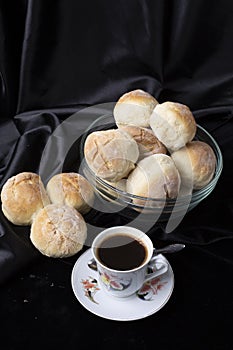 Small breads close-up and a cup of coffee