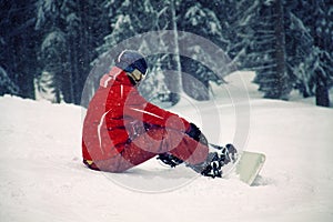 Snowboard rider resting on the hill photo