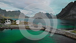 Small bridge stone dam connects town parts against fjords