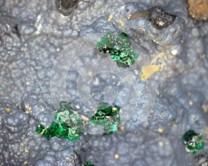 Small bright green malachite (copper carbonate) crystals on matrix