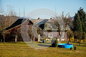 Small brown house, Old wooden timber hut with a fence, Cottage surrounded by trees, Bohemian Paradise, rock formation Besednicke