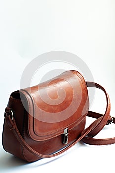 A small brown leather handbag  on white background. fashionable leather bag handmade. ladies bag. fashion style