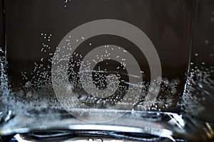 Small bubbles of water in a transparent glass vase from under flowers