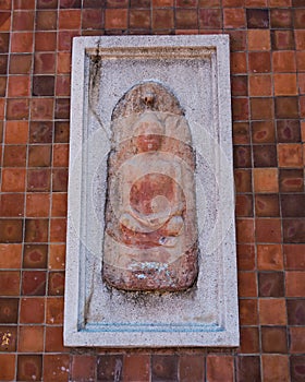Small buddha image at wall