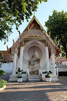 A small Buddhist shrine with a luxuriously decorated roof