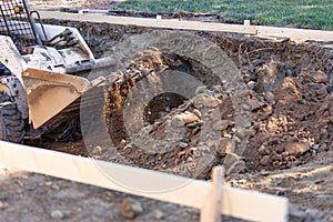 Small Bulldozer Digging In Yard For Pool Installation