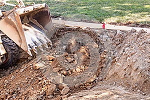 Small Bulldozer Digging In Yard For Pool Installation