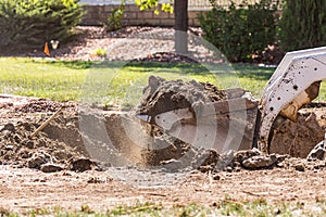 Small Bulldozer Digging In Yard For Pool Installation