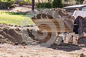 Small Bulldozer Digging In Yard For Pool Installation