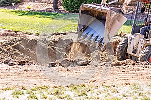 Small Bulldozer Digging In Yard For Pool Installation