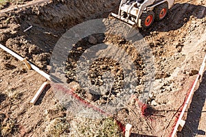 Small Bulldozer Digging In Yard For Pool Installation