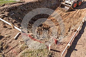 Small Bulldozer Digging In Yard For Pool Installation