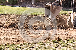 Small Bulldozer Digging In Yard For Pool Installation